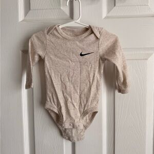 Nike Long-Sleeve Baby Bodysuit in Light Beige with Black Swoosh